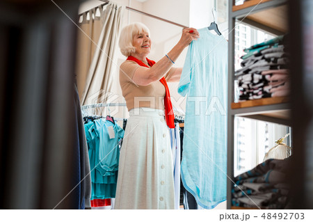 Emotional grey haired woman being satisfied with shopping 48492703