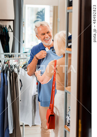 Emotional grey haired customer doing shopping with his wife 48492823