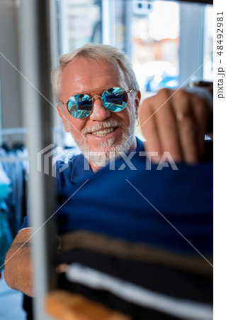 Close up of pleased grey haired man doing shopping 48492981