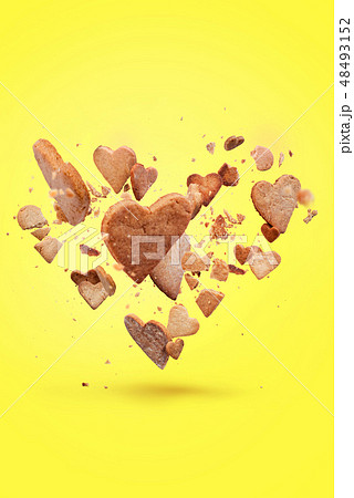 Card with flying crisp biscuit in the shape heart 48493152