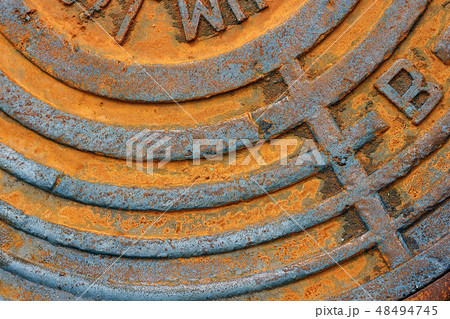Fragment of an old rusty sewer hatch. 48494745