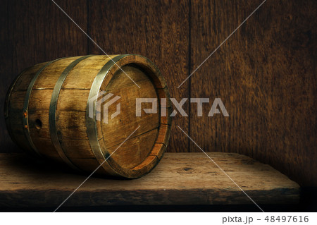 Wooden barrel and worn old table of wood. Wooden barrel and worn old table of wood. 48497616