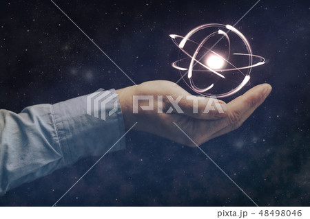 Human hand holding atom. Nebula dust.  48498046