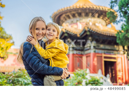 Enjoying vacation in China. Mom and son in Forbidden City. Travel to China with kids concept. Visa Enjoying vacation in China. Mom and son in Forbidden City. Travel to China with kids concept. Visa 48499085