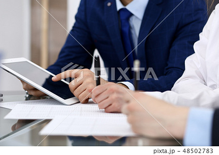 Businessman using laptop at meeting, closeup of hands. Business operations concept Businessman using laptop at meeting, closeup of hands. Business operations concept 48502783
