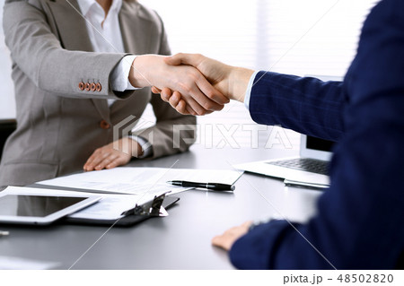Business people shaking hands, finishing up a meeting. Papers signing, agreement and lawyer Business people shaking hands, finishing up a meeting. Papers signing, agreement and lawyer 48502820