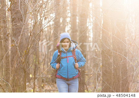 adventure, travel, tourism, hike and people concept - smiling tourist woman walking with backpacks 48504148
