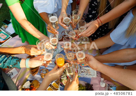Group of people having outdoor picnic meal togethe Group of people having outdoor picnic meal togethe 48506781