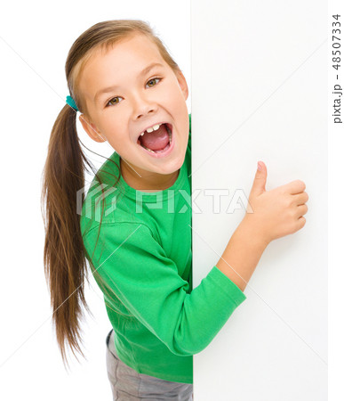 Little girl is looking from out blank board Little girl is looking from out blank board 48507334