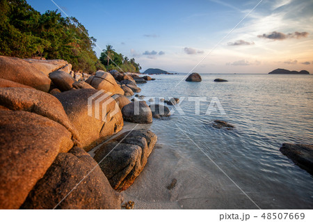 Sea sunset rocks beach on blue sky background. Beauty evening sunrise. Blue background. Sea sunset rocks beach on blue sky background. Beauty evening sunrise. Blue background. 48507669