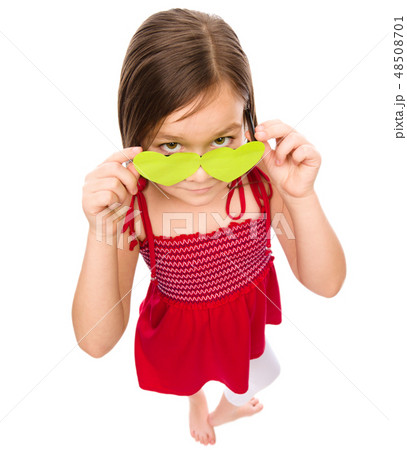Girl is looking over her heart-shaped glasses Girl is looking over her heart-shaped glasses 48508701