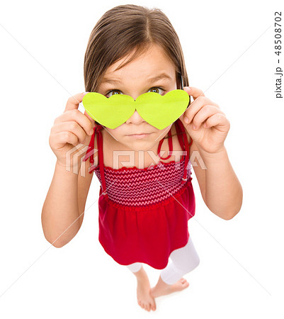 Little girl is holding hearts over her eyes 48508702