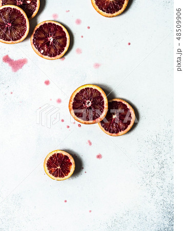 Raw blood red orange slice on a light background. Raw blood red orange slice on a light background. 48509906