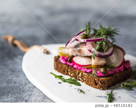 Dark rye bread with herring slices Dark rye bread with herring slices 48510182