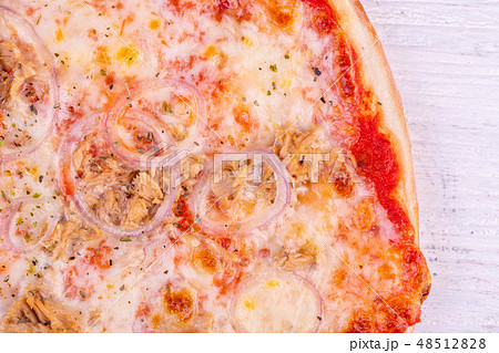 Fish pizza with pieces of a salmon with onions and 48512828
