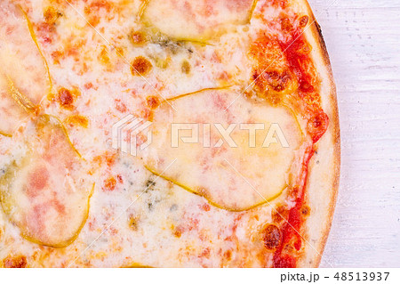 Fragment of pizza with pear and cheese 48513937