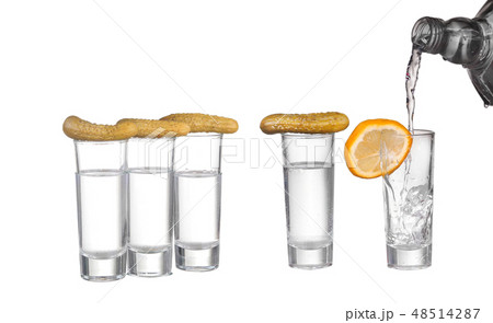 Glass of vodka and cucumber isolated on white 48514287