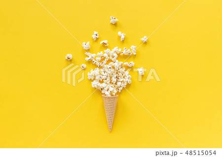 Scattered popcorn in ice cream waffle cone  48515054