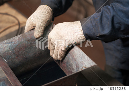 Blacksmith soldering a metal plate shot from above Blacksmith soldering a metal plate shot from above 48515288