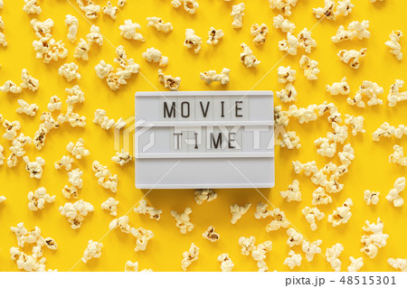 Scattered popcorn and lightbox text Movie time Scattered popcorn and lightbox text Movie time 48515301