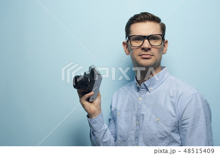 Young male photographer holding a new camera 48515409