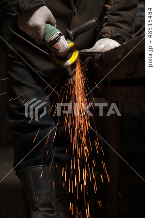 Blacksmith Polishes Metal Products Using A Grinding Machine Blacksmith Polishes Metal Products Using A Grinding Machine 48515484