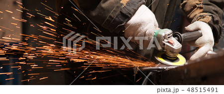 Blacksmith Polishes Metal Products Using A Grinding Machine Blacksmith Polishes Metal Products Using A Grinding Machine 48515491