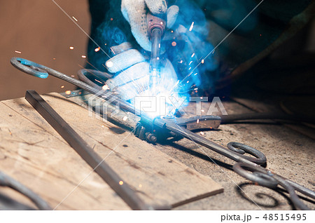 Blacksmith Polishes Metal Products Using A Grinding Machine Blacksmith Polishes Metal Products Using A Grinding Machine 48515495