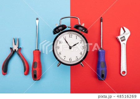 set of tools with alarm clock isolated on blue-red background set of tools with alarm clock isolated on blue-red background 48516269