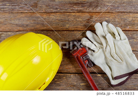 Yellow hard hat and leather work gloves Yellow hard hat and leather work gloves 48516833