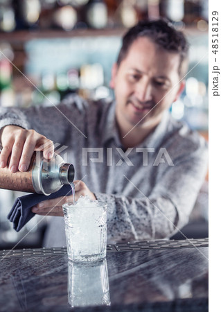 Professional barman making cocktail drink. 48518129