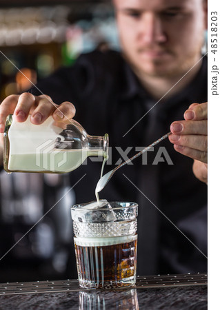 Professional barman making cocktail drink. Professional barman making cocktail drink. 48518203