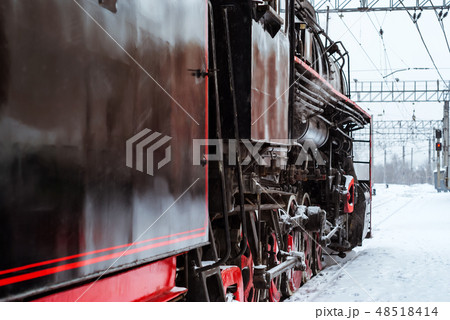 steam locomotive at the station in winter 48518414