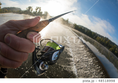Man fishing in river with fly rod during summer morning. Man fishing in river with fly rod during summer morning. 48518998