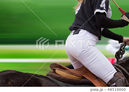 Polo woman player is riding on a horse. Polo woman player is riding on a horse. 48519000