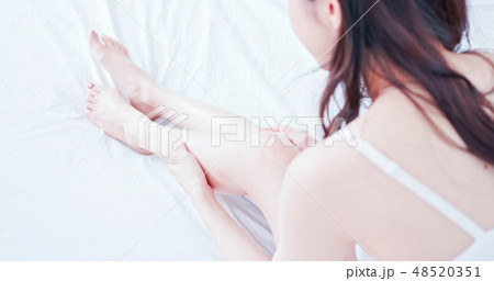 asian woman touch her leg asian woman touch her leg 48520351