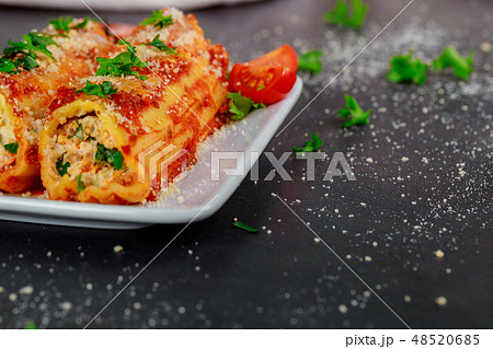Cannelloni with spinach and ricotta baked in sauce 48520685