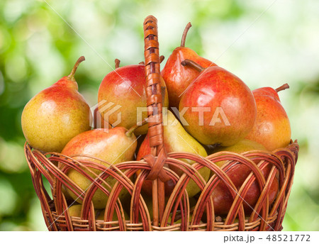 pears in a wicker basket with blurred background pears in a wicker basket with blurred background 48521772