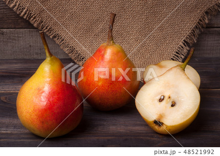 two pears with half on a dark wooden background two pears with half on a dark wooden background 48521992