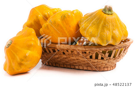 yellow pattypan squash in a wicker basket isolated on white background 48522137