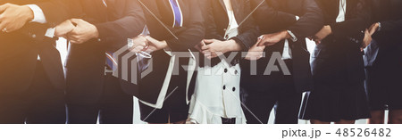 Many happy business people holding hands together. Many happy business people holding hands together. 48526482