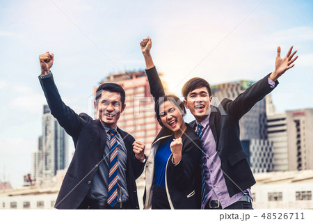Businessmen and businesswoman celebrate success. 48526711