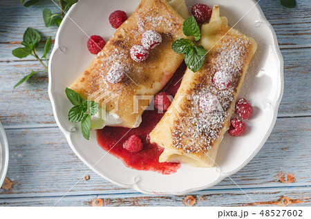 Cheese blintzes pancakes with fresh fruit 48527602