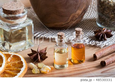 Bottles of essential oil with frankincense, spices 48530331