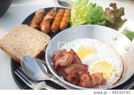 Fried eggs, bacon and sausage on pan. Breakfast Fried eggs, bacon and sausage on pan. Breakfast 48530745