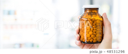 Hand holding a bottle of medicine Hand holding a bottle of medicine 48531296