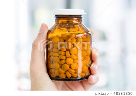 Hand holding a bottle of medicine Hand holding a bottle of medicine 48531850