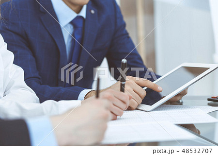 Businessman using laptop at meeting, closeup of hands. Business operations concept Businessman using laptop at meeting, closeup of hands. Business operations concept 48532707
