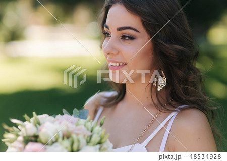 Portrait of yound girl with bouquet. Charming lady in sunny summer day. Stylish woman Portrait of yound girl with bouquet. Charming lady in sunny summer day. Stylish woman 48534928