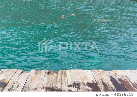 Pov on raft with people snorkeling in sea 48536519